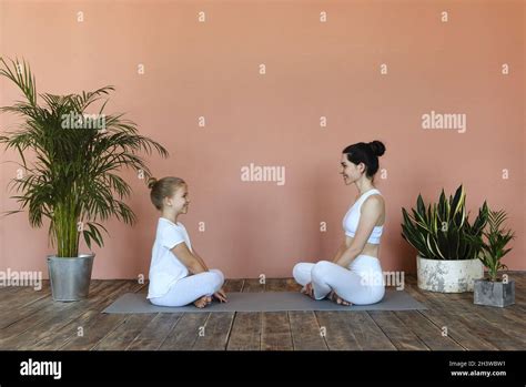 Smiling Mother And Daughter Practicing Yoga Together Stock Photo Alamy