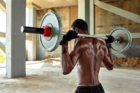 Premium Photo Athletic Black Young Man Lifting A Heavyweight Barbell