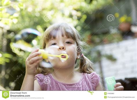 Girl Blowing Soap Bubbles In Backyard Stock Photo Image Of Brunet