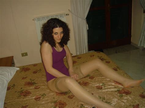 European Brunette Amateur Wearing Shiny Tan Stockings On Bed 31 Pics