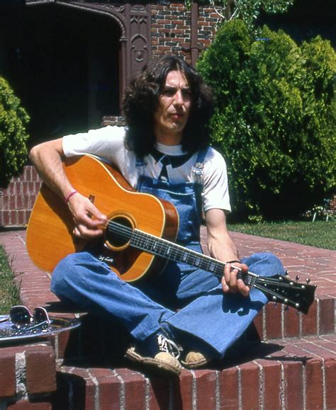 All things must pass, the light that has lighted the world, beware. George Harrison on an acoustic guitar : beatles
