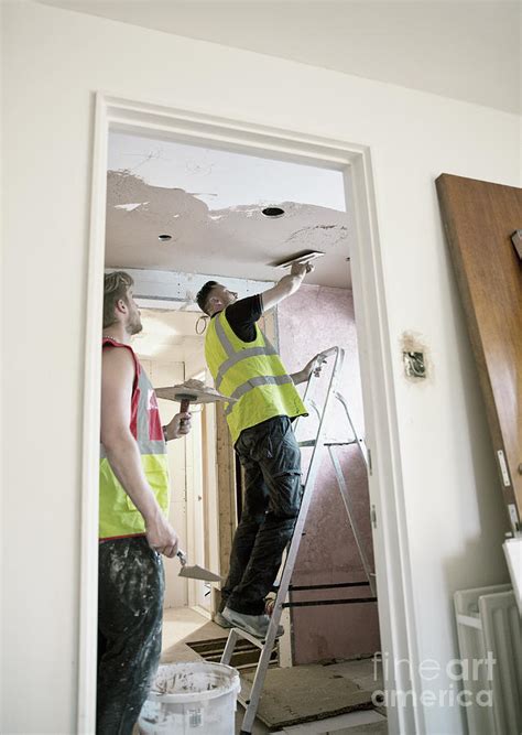 So you're ready to take on plastering your ceiling, are you? Construction Workers Plastering Ceiling In House ...