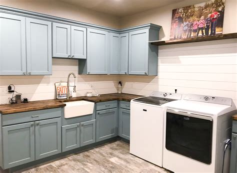 Laundry rooms are essential to any home, but their organizational needs can often get overlooked. Large, farmhouse laundry room. Shiplap, blue cabinets ...