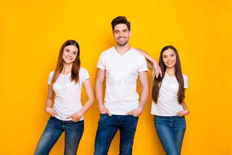 Portrait Of Cheerful Ladies With Guy Having Long Foxy Ginger Hair Putting Their Hands In Pockets