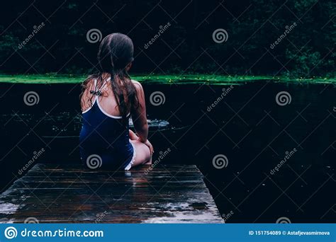 Girl Sitting On Pier Looking Back Stock Image Image Of Alone