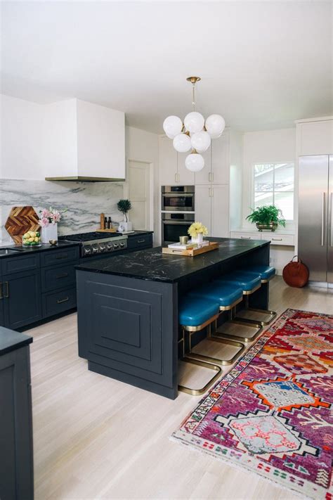 Slabs of marble on the exterior cabinets and the island create a cohesive look. Marble Kitchen Island Ideas and Inspiration | Hunker