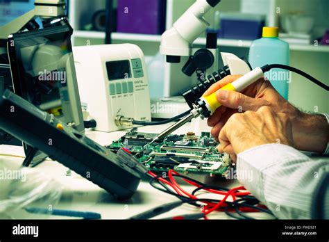 Soldering A Micro Chip Onto A Printed Circuit Board Stock Photo Alamy