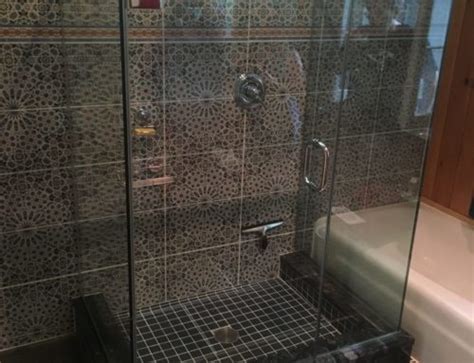 White stone walls and floor add to the sleek contemporary look. Curb vs. Curbless Shower Enclosures - Absolute Shower Doors