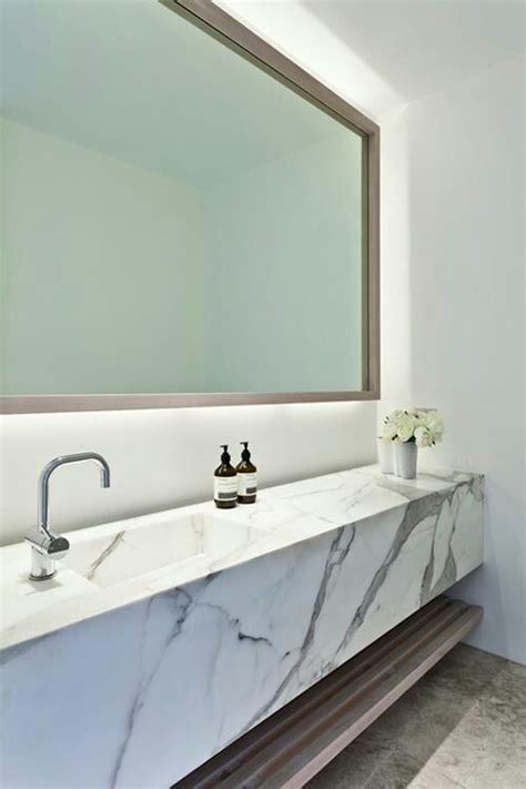 These simple elements are mimicked in the designs of the tub and sink making the space look larger with a cohesive design. 48 Luxurious Marble Bathroom Designs - DigsDigs