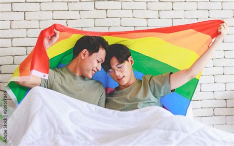 Two Asian Cheerful Lovely Pride Male Gay Men Lover Couple Partner Smiling Sitting Holding Hands