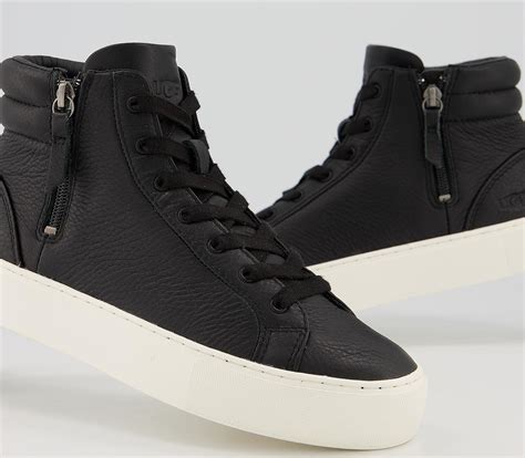 The 3mm foam insole with a synthetic leather lining ensures cushioning and comfort, while the functional zipper and padded back collar offer added convenience. UGG Olli High Top Trainers Black - Ankle Boots