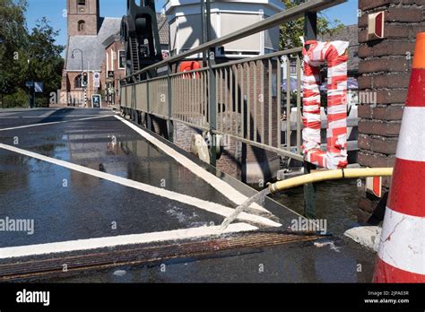 Cold Water From Hose Cools The Movable Parts Of A Drawbridge To Prevent It From Expanding In