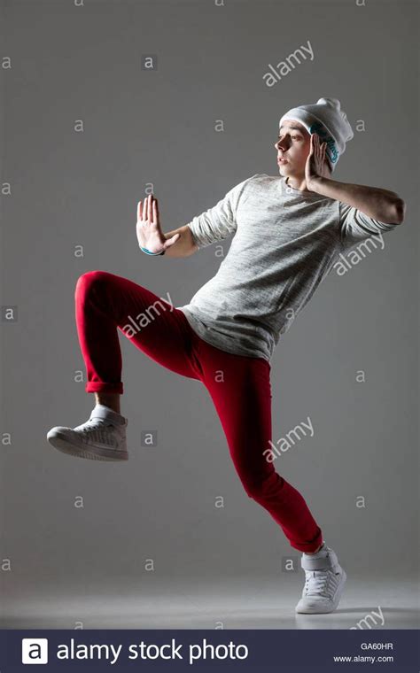 Portrait Of One Funny Hipster Young Man Dancing Wearing Casual Red Jeans And Beanie Cool Hip