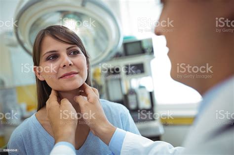 Doctor Examining A Female Patients Neck Stock Photo Download Image