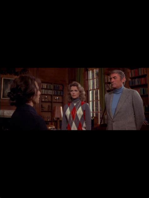 Two Women And A Man Standing Next To Each Other In A Room With Bookshelves