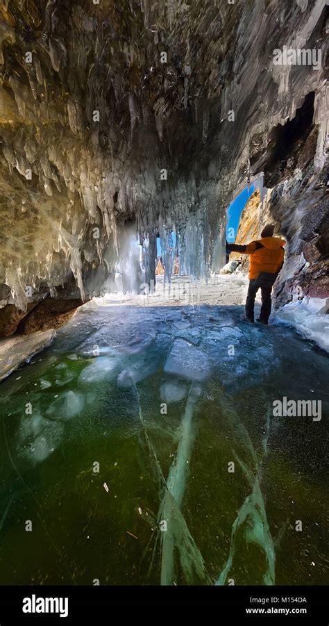 Panorama Man In An Ice Cave With Icicles On Baikal Olkhon Stock Photo