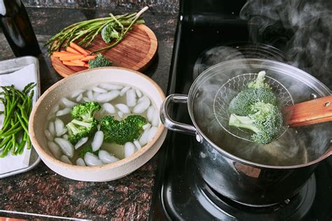Broccoli And Other Vegetables Are Being Cooked In Boiling Water On The