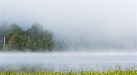 Summer Morning Foggy Mist Rises From Lake Into Cool Air Stock Photo