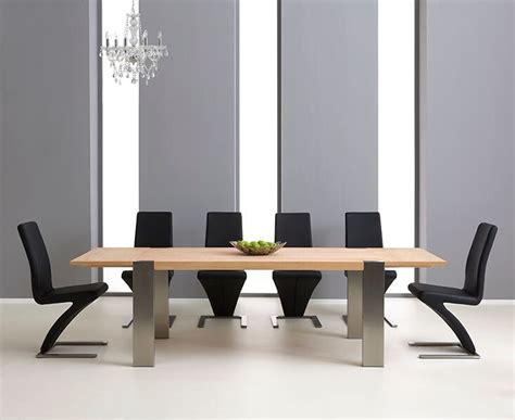 Rated 4 out of 5 stars. Extending oak dining table and 10 black chairs - Homegenies