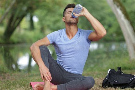 Man Drinking Water After Yoga Practice Outdoors Stock Image Image Of
