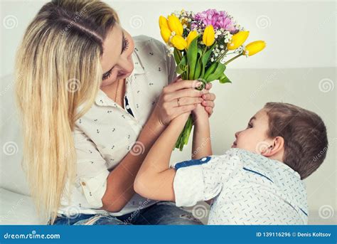 Son Gives His Beloved Mother A Beautiful Bouquet Of Tulipsthe Concept