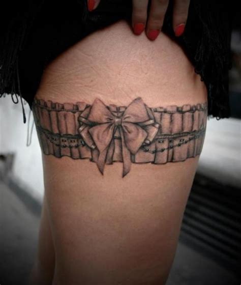 Nice grey ink garter belt tattoo. Realistic Thigh Garter Tattoo by 2nd Face