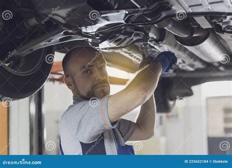 Professional Mechanic Working Under A Car Stock Photo Image Of