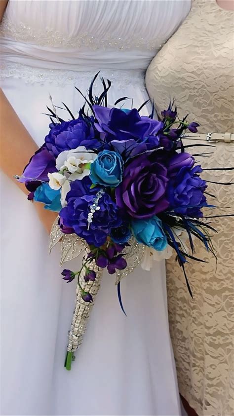 The Brides Bouquet Is Blue And White With Purple Flowers On Its Side