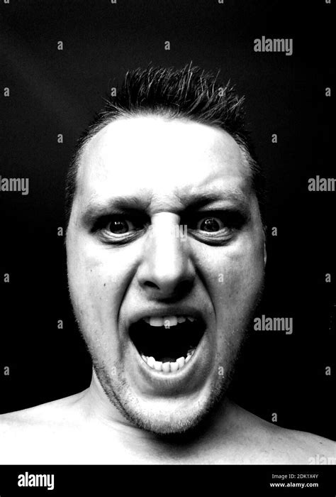 Close Up Portrait Of Angry Man Screaming In Darkroom Stock Photo Alamy