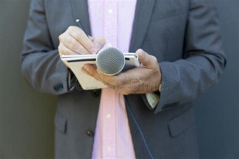 Journalist At News Conference Or Media Event Writing Notes Holding