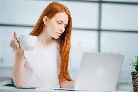 Beautiful Hipster Redhead Woman Using Laptop In Office Stock Image