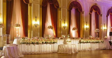 A Banquet Hall Decorated With White And Pink Flowers