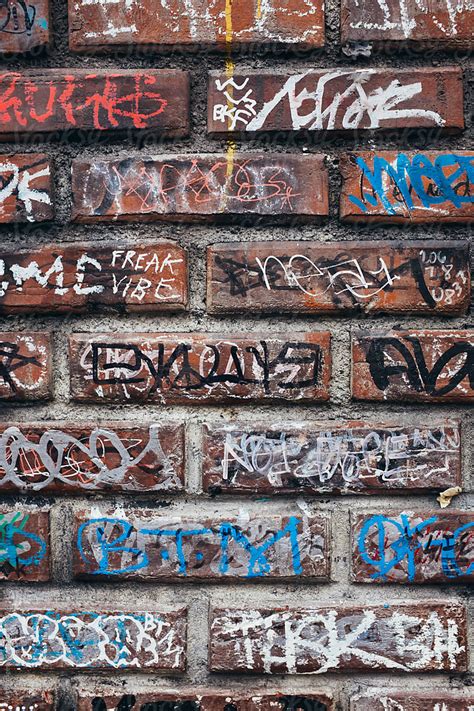 Detail Of Graffiti Markings On Building Wall By Stocksy Contributor