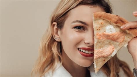 Premium Photo Woman Eating Pizza In Bed
