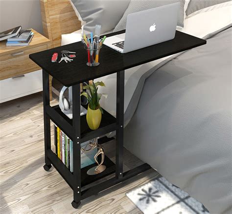 The wheels also let you move it. Supreme Sofa Bed Side Table Laptop Desk with Shelves & Wheels