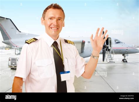 Airline Pilot Wearing Uniform With Epaulettes Waving With Passenger