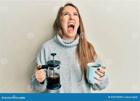 Young Blonde Woman Drinking A Cup Of Italian Coffee Angry And Mad