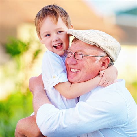 Grandfather Smiling With Grandson In Arms Life Smile Dental Care