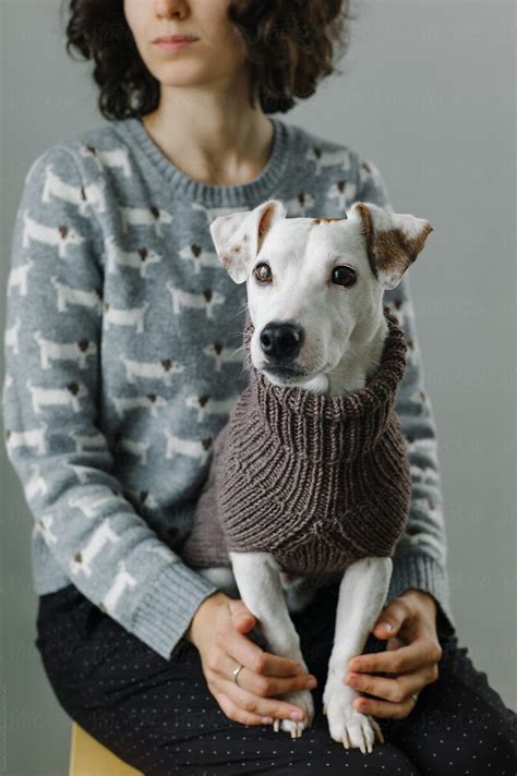 Woman With Dog Wearing Sweater On Knees Stocksy United Studio Shoot