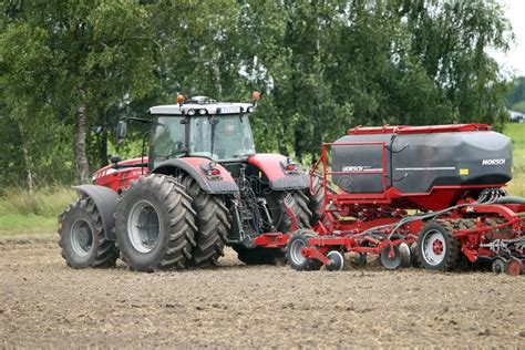 Farmer Plowing The Field Cultivating Tractor In The Field Red Farm