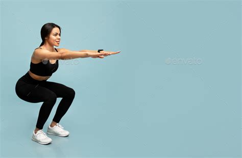 Fitness And Sport Slim African American Lady Doing Deep Squat Exercises Working Out Over Blue