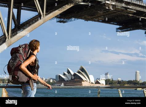 A Backpacker Looks Across To The Harbour Bridge And Opera House Sydney