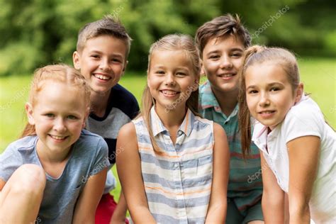 Group Of Happy Kids Or Friends Outdoors Stock Photo By ©syda