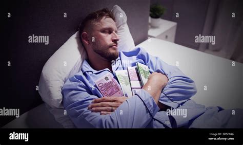 Man Sleeping On Bed With Bundle Of Currency Notes Stock Photo Alamy