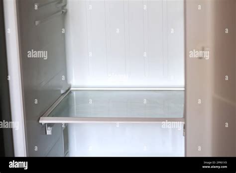 Empty Open Fridge With Shelves Refrigerator Inside Of An Empty White