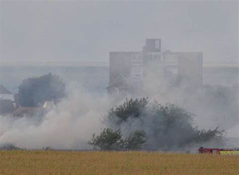 Smoke Billows Across Field As Firefighters Tackle Blaze Near