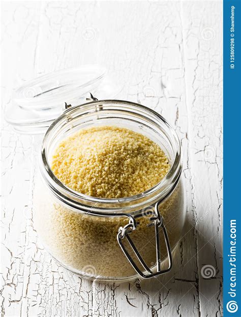 Heap of Raw, Uncooked Couscous in Glass Jar on Wooden Table Stock Photo - Image of dish, macro ...