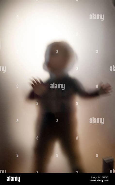 Silhouette Toddler Behind Frosted Glass Stock Photo Alamy