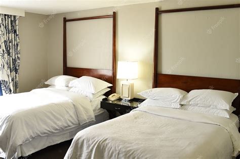 Premium Photo Two Beds With White Linen And Pillows In Hotel Or Motel