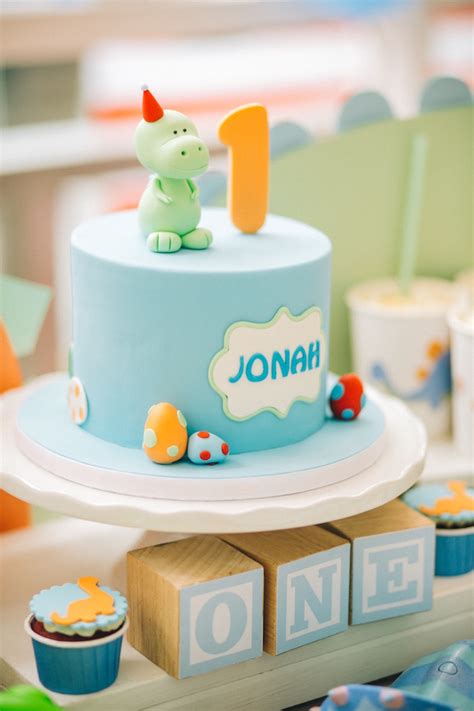 Its topper is a mom in a straw hat pushing a pink baby buggy which holds a smiling baby. Kara's Party Ideas Modern Dinosaur Birthday Party | Kara's ...